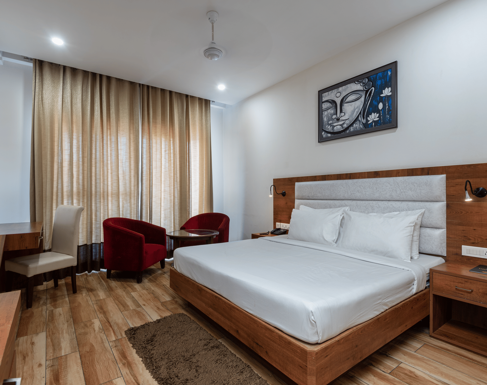 A Club Balcony Room featuring a bed, a teapoy and chairs at DLS The Classio